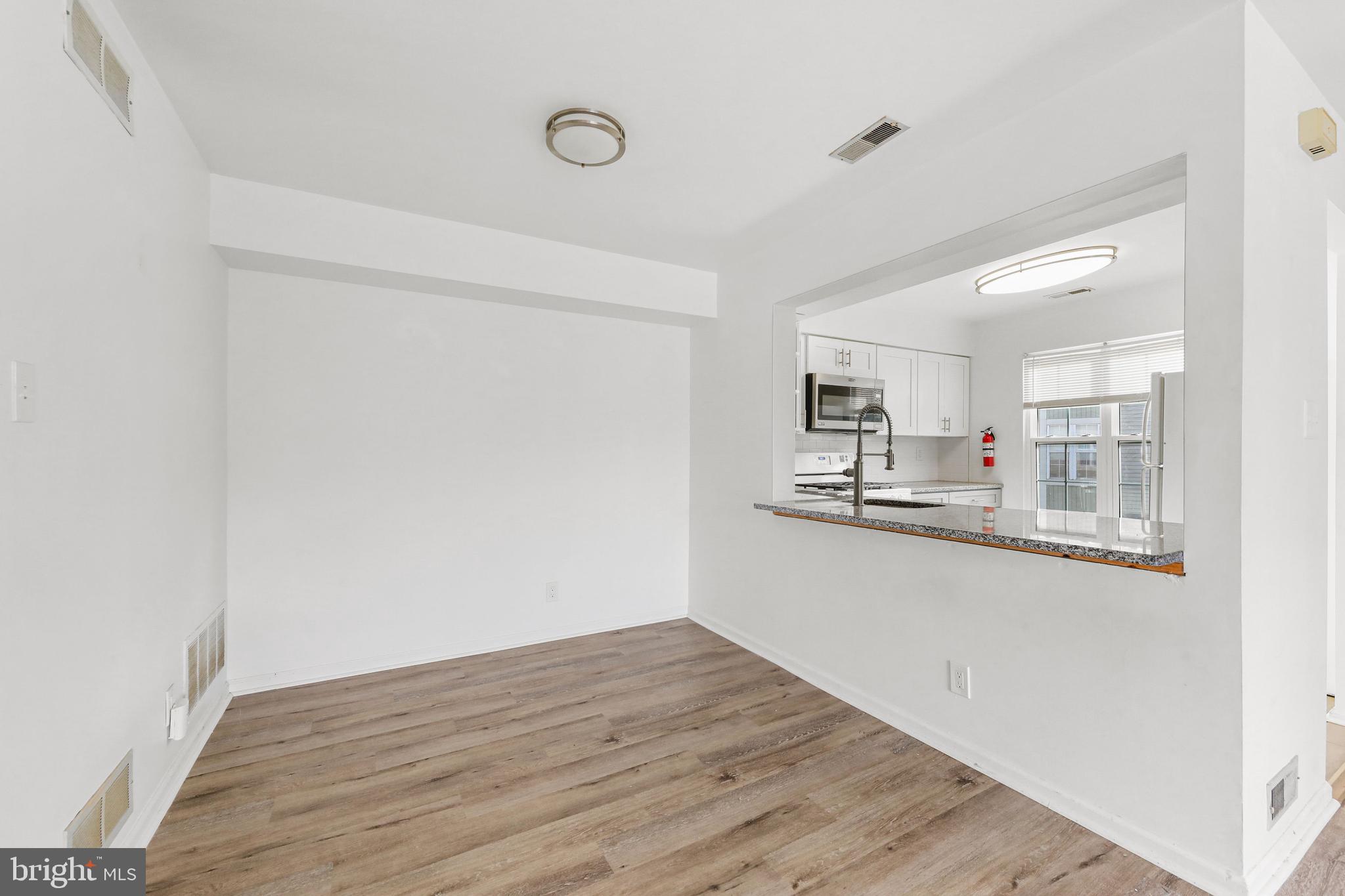 4204 Fenwick Lane Mount Laurel, NJ 08054 - Photo 10 of 27 a view of a kitchen with wooden floor and a window