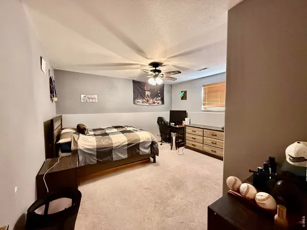 a bedroom with furniture and a large window