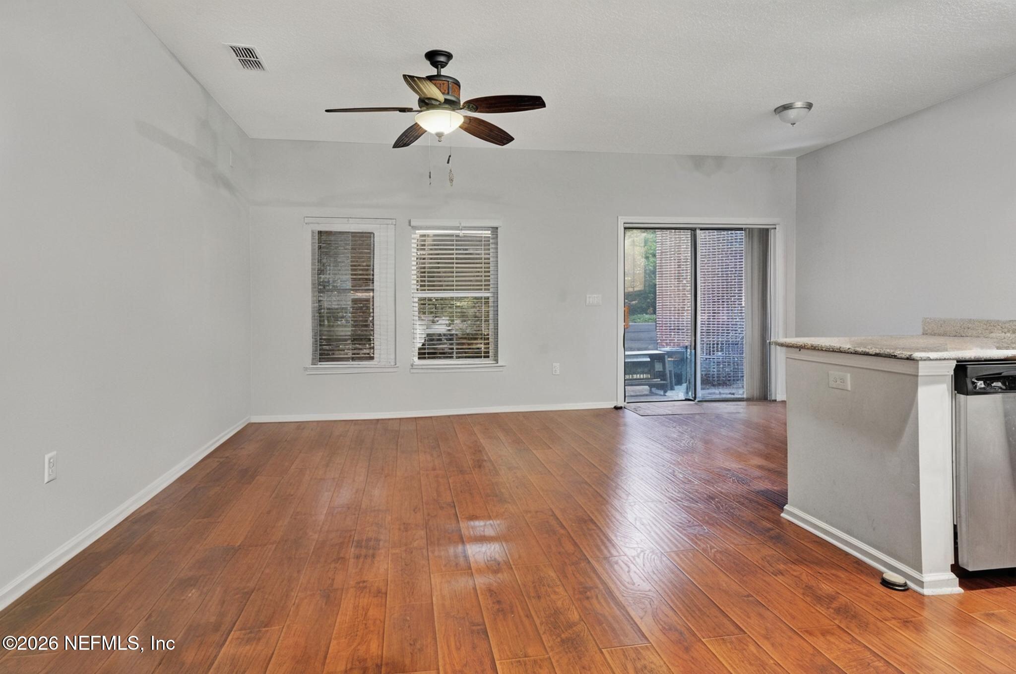 1537 Landau Road Jacksonville, FL 32225 - Photo 2 of 12 a view of an empty room with wooden floor and a window