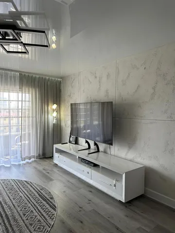 a living room with hard wood flooring and furniture