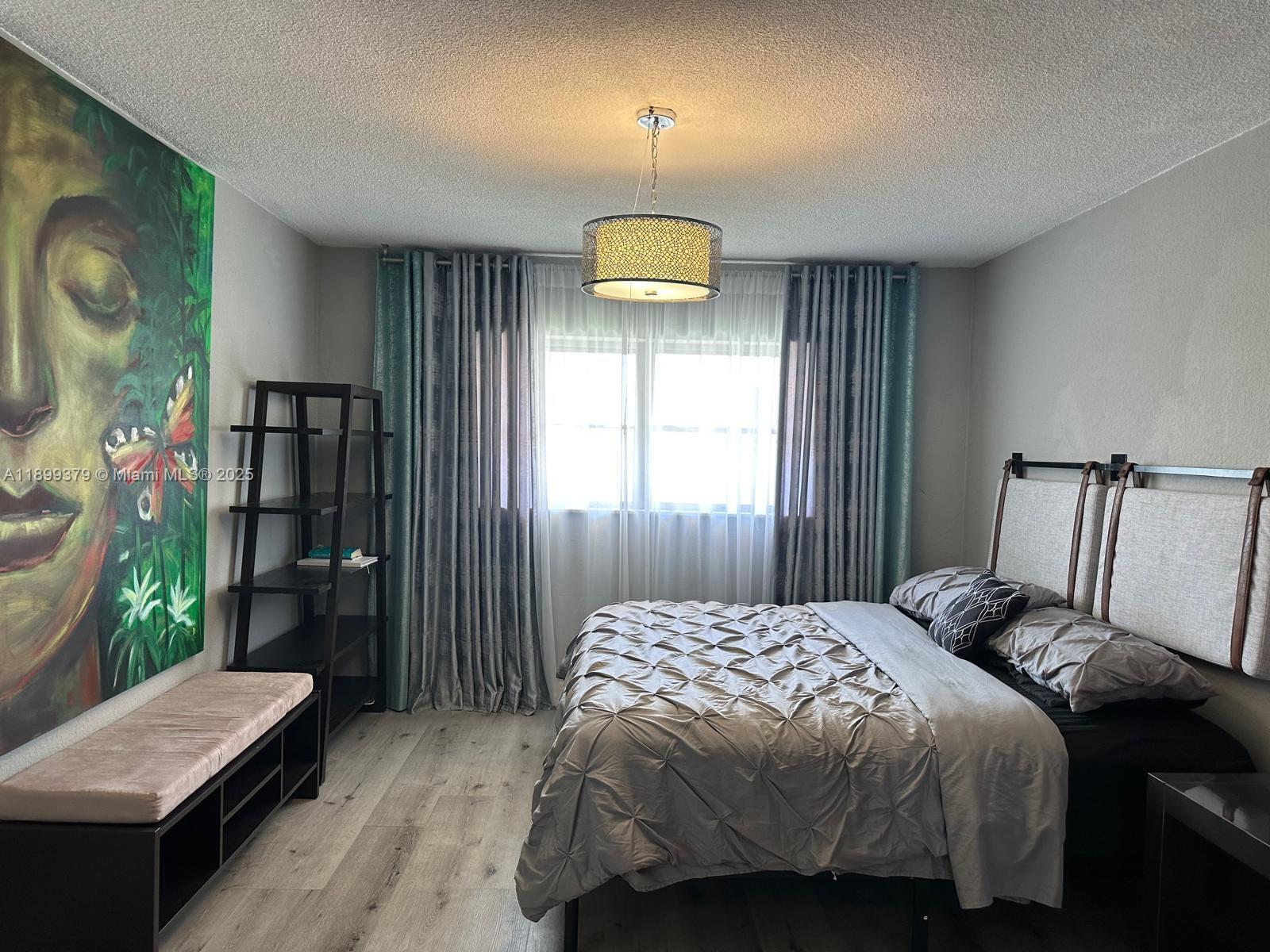 20201 Northeast 29th Court, Unit D335 Aventura, FL 33180 - Photo 8 of 12 a bedroom with a bed and a window