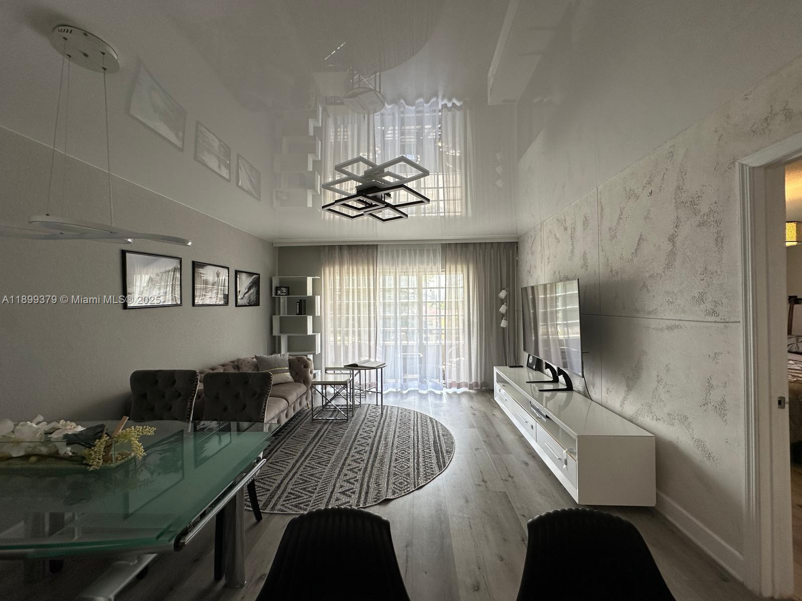 20201 Northeast 29th Court, Unit D335 Aventura, FL 33180 - Photo 10 of 12 a living room with furniture and a large window