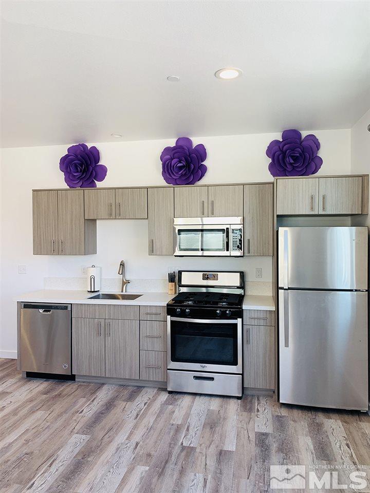 237 East Arroyo Street Reno, NV 89502 - Photo 3 of 10 a kitchen with a refrigerator and white cabinets