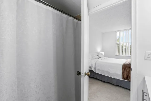 a bathroom with a toilet a sink and a mirror