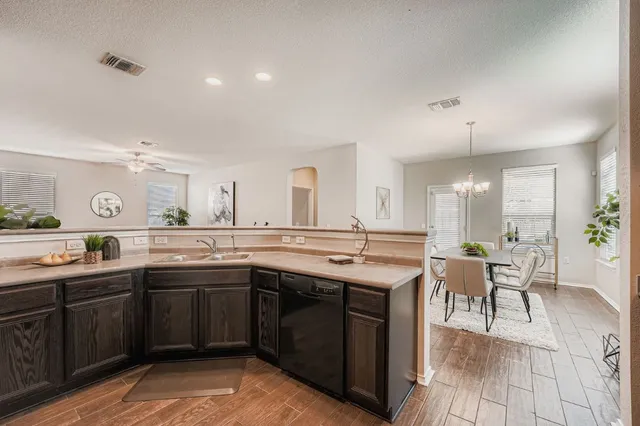 a large kitchen with a table and chairs in it