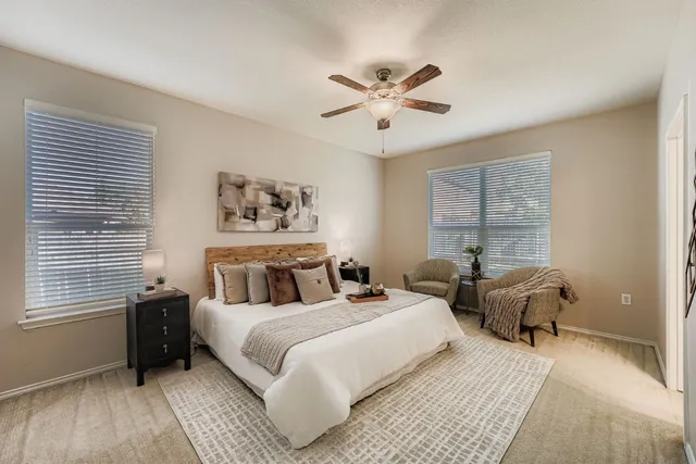 a bedroom with two beds and a window