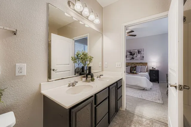 a bathroom with a sink a toilet and mirror