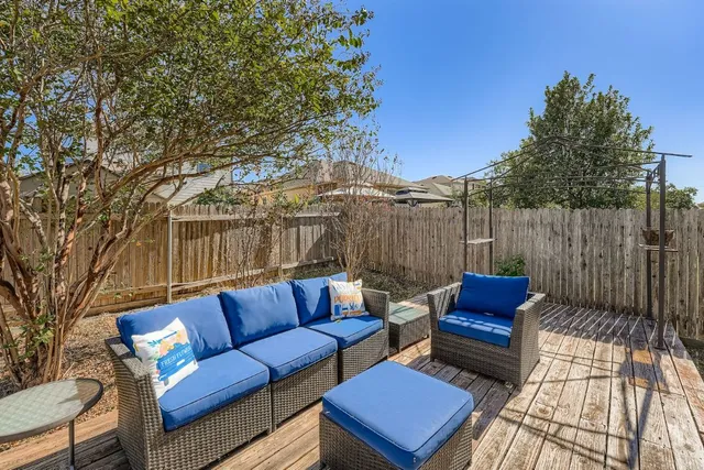 a outdoor sitting area with furniture and wooden floor