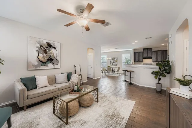a living room with furniture and kitchen view