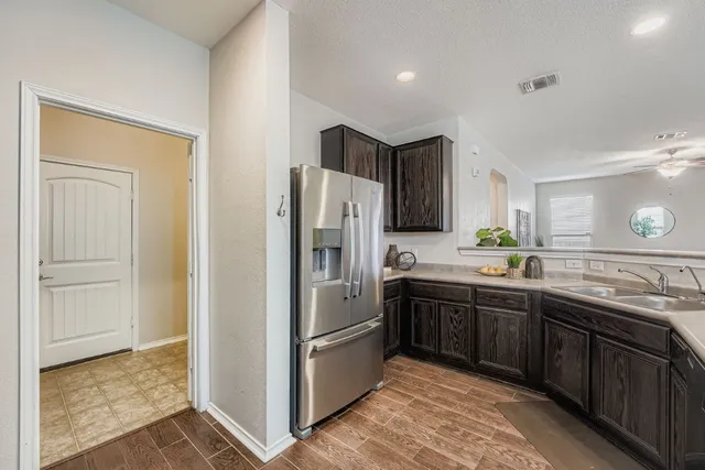 a kitchen with stainless steel appliances granite countertop a refrigerator and a sink