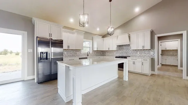 a large kitchen with cabinets and stainless steel appliances