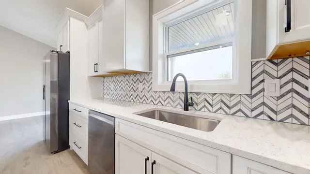a kitchen with a sink and a refrigerator