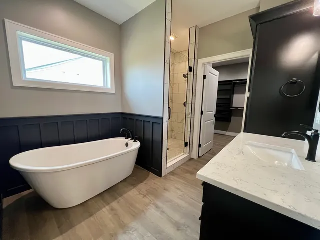 a white bath tub sitting in a bathroom and bathroom
