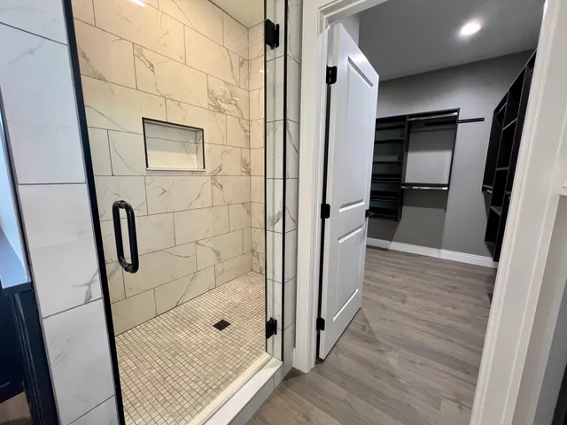 a bathroom with a shower and a glass door