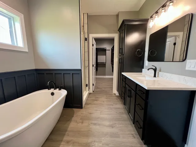 a bathroom with a double vanity sink and a bathtub