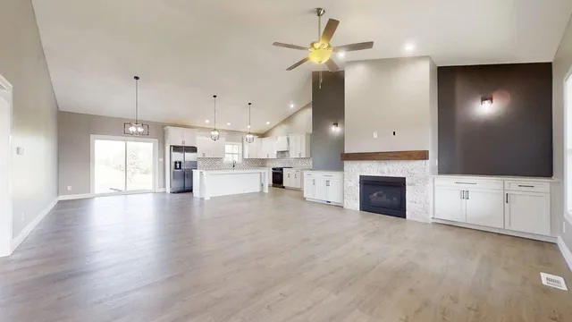 a view of a kitchen with a sink and a fireplace