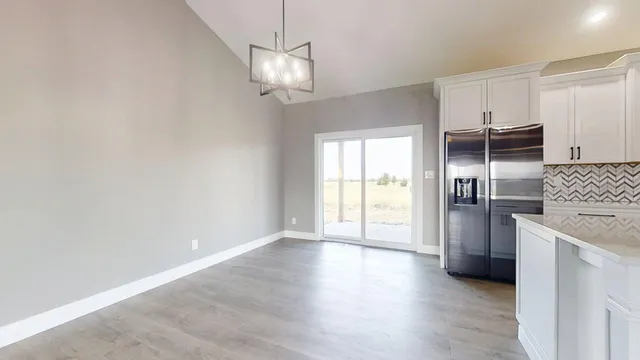 a view of a kitchen with a dishwasher cabinets and a wooden floor