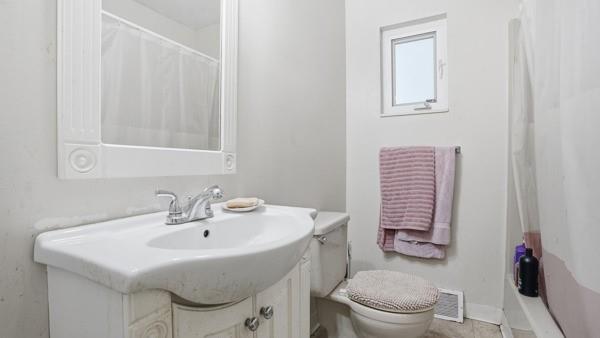 1311 Bingham Street Pittsburgh, PA 15203 - Photo 13 of 25 a bathroom with a sink a toilet and mirror