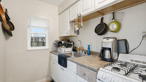1311 Bingham Street Pittsburgh, PA 15203 - Photo 15 of 25 a kitchen with a stove a sink and a stove top oven