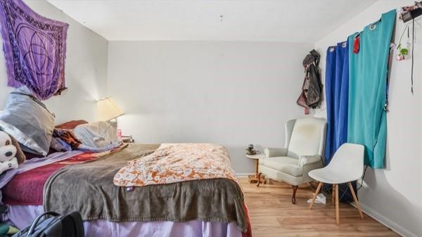 1311 Bingham Street Pittsburgh, PA 15203 - Photo 8 of 25 a bedroom with a bed a painting on the wall and a lamp