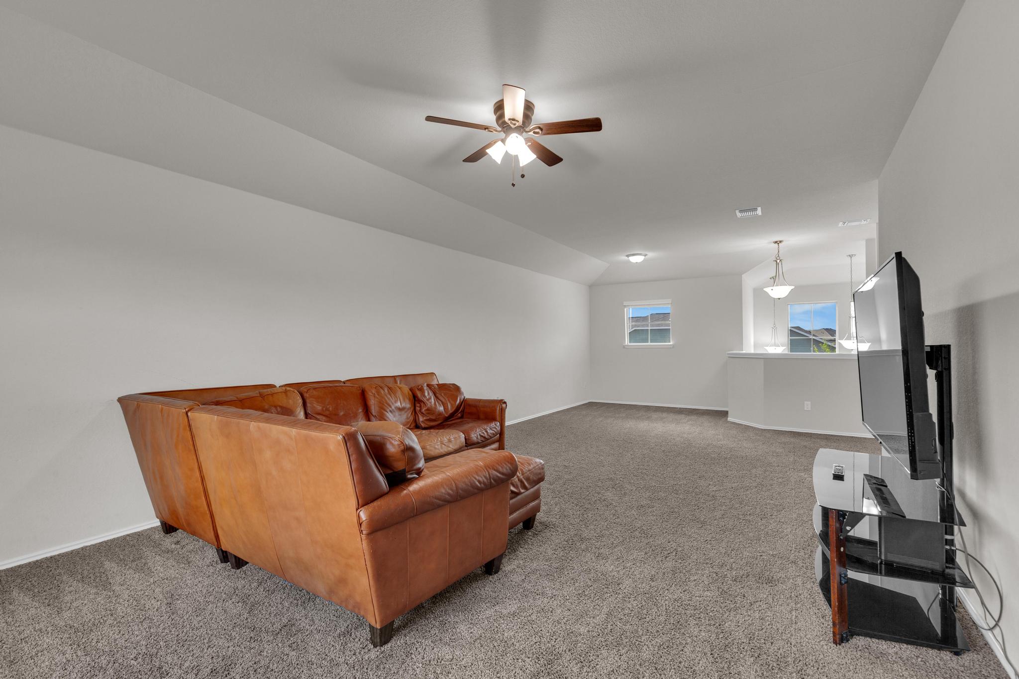 104 Uncle Billy Way Jarrell, TX 76537 - Photo 24 of 38 Unwind in this generously sized leisure space, featuring a vaulted ceiling and soft carpet.