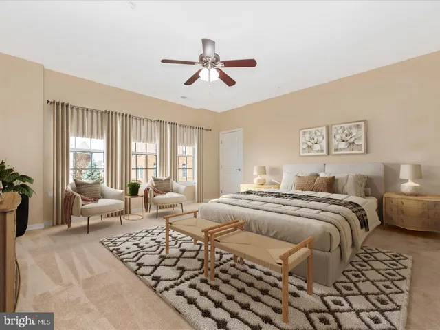 a bedroom with a bed painting on wall and a large window