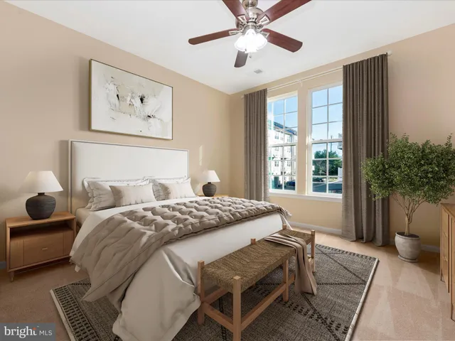 a bedroom with a bed and a large window