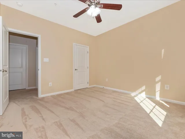 a front view of a building with car parked