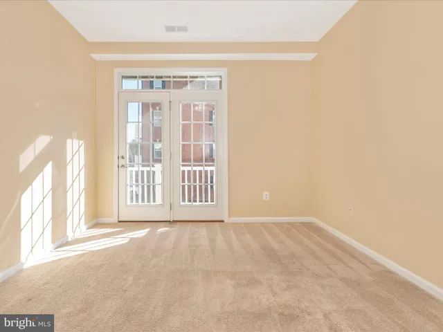 a front view of a residential apartment building with a yard