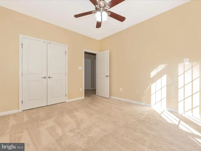 a front view of a house with a yard and potted plants
