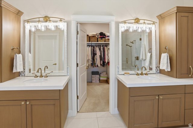 534 East Fish Hatchery Road Mantua, UT 84324 - Photo 49 of 87 Full bath featuring two vanities, a spacious closet, a stall shower, and light tile patterned floors