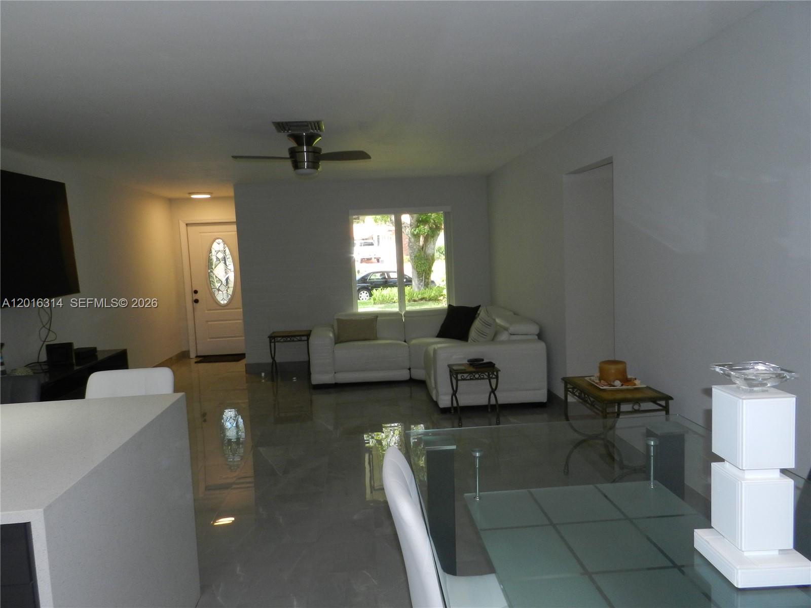 305 Northwest 42nd Street Boca Raton, FL 33431 - Photo 25 of 31 a living room with furniture and a flat screen tv