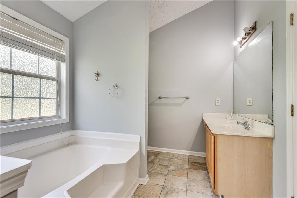 3337 Baymount Way Lawrenceville, GA 30043 - Photo 29 of 47 a bathroom with a tub sink and mirror