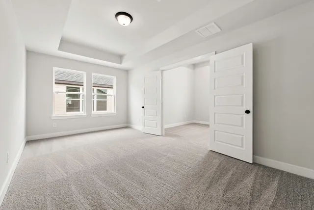 an empty room with windows and closet