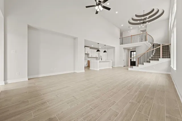 a view of a room with wooden floor and ceiling fan
