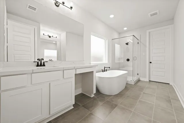 a bathroom with a bathtub a sink and a mirror