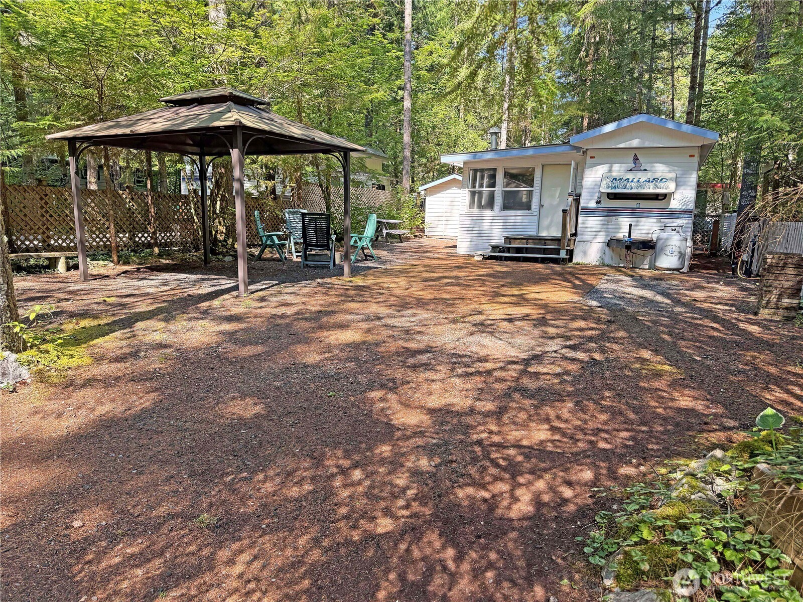 a view of a house with backyard and sitting area
