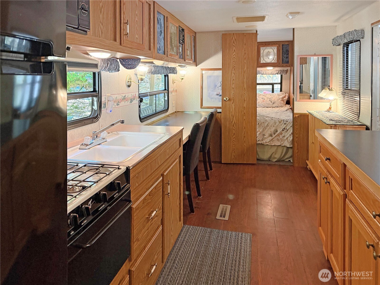 165-4 Christmas Tree Circle Maple Falls, WA 98266 - Photo 5 of 36 a kitchen with stainless steel appliances granite countertop a refrigerator a stove and a sink with wooden floor