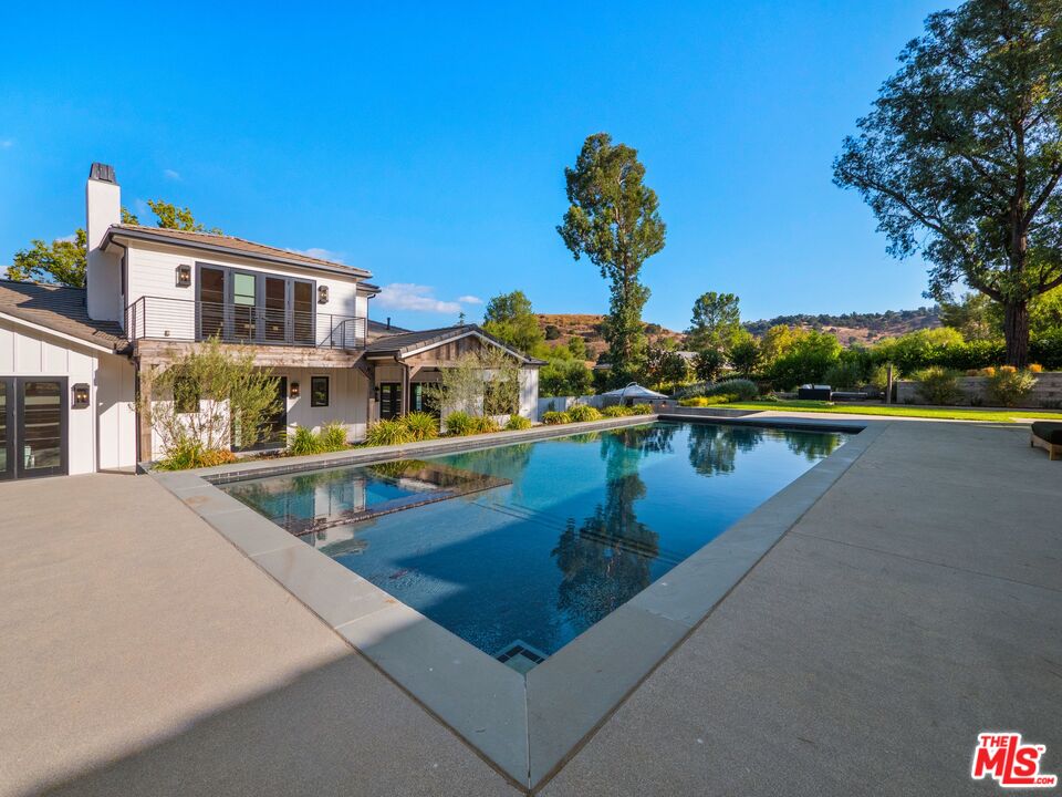 5207 Round Meadow Road Hidden Hills, CA 91302 - Photo 40 of 50 a view of swimming pool with a yard