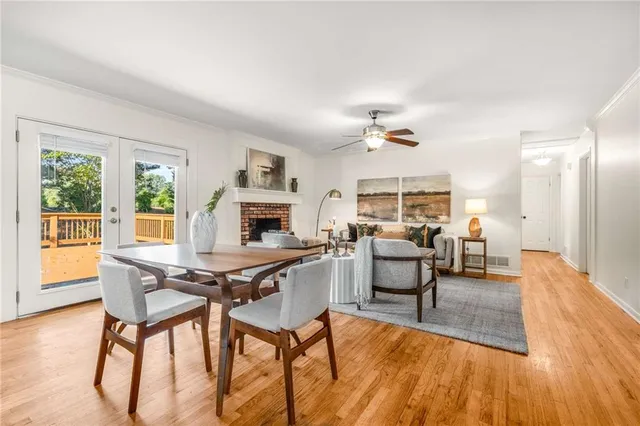 a living room with furniture a fireplace and a large window