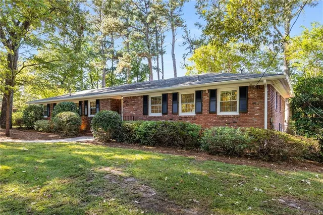 a view of an house with backyard space and garden