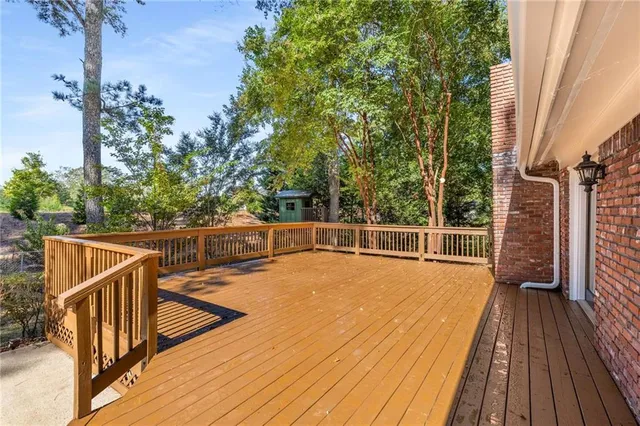 a view of a balcony with wooden floor and fence
