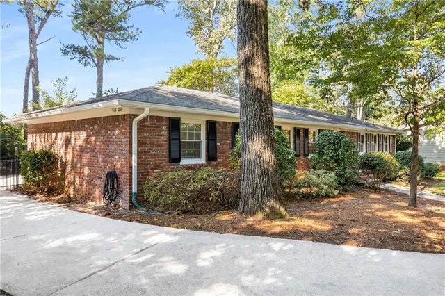 a front view of a house with a yard and potted plants