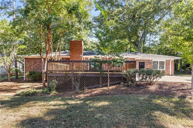 a view of a house with backyard and a sitting area