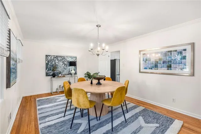 a dining room with furniture a rug and a chandelier