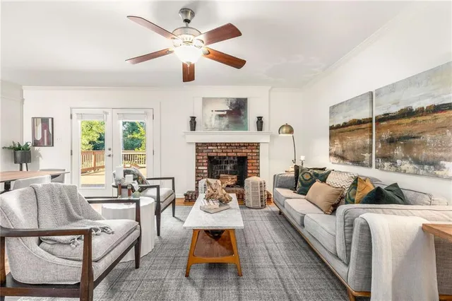 a living room with furniture fireplace and a large window
