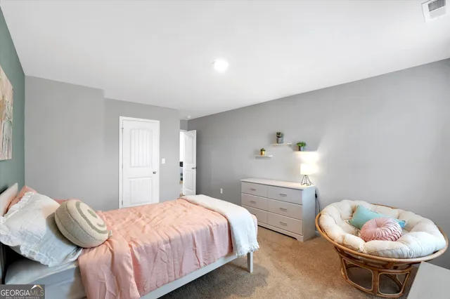 a bedroom with a bed and a chair