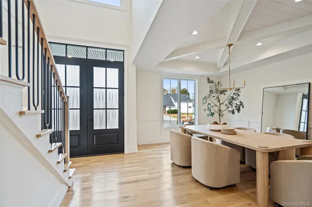 a room with stainless steel appliances kitchen island granite countertop a sink and a stove