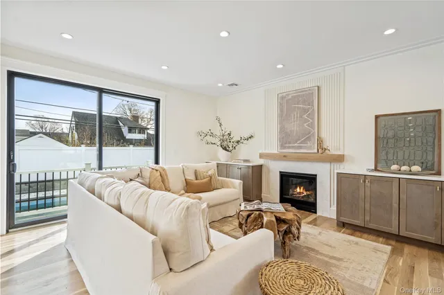 a living room with furniture a fireplace and a table