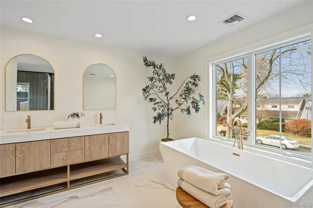 a spacious bathroom with a double vanity sink and a toilet